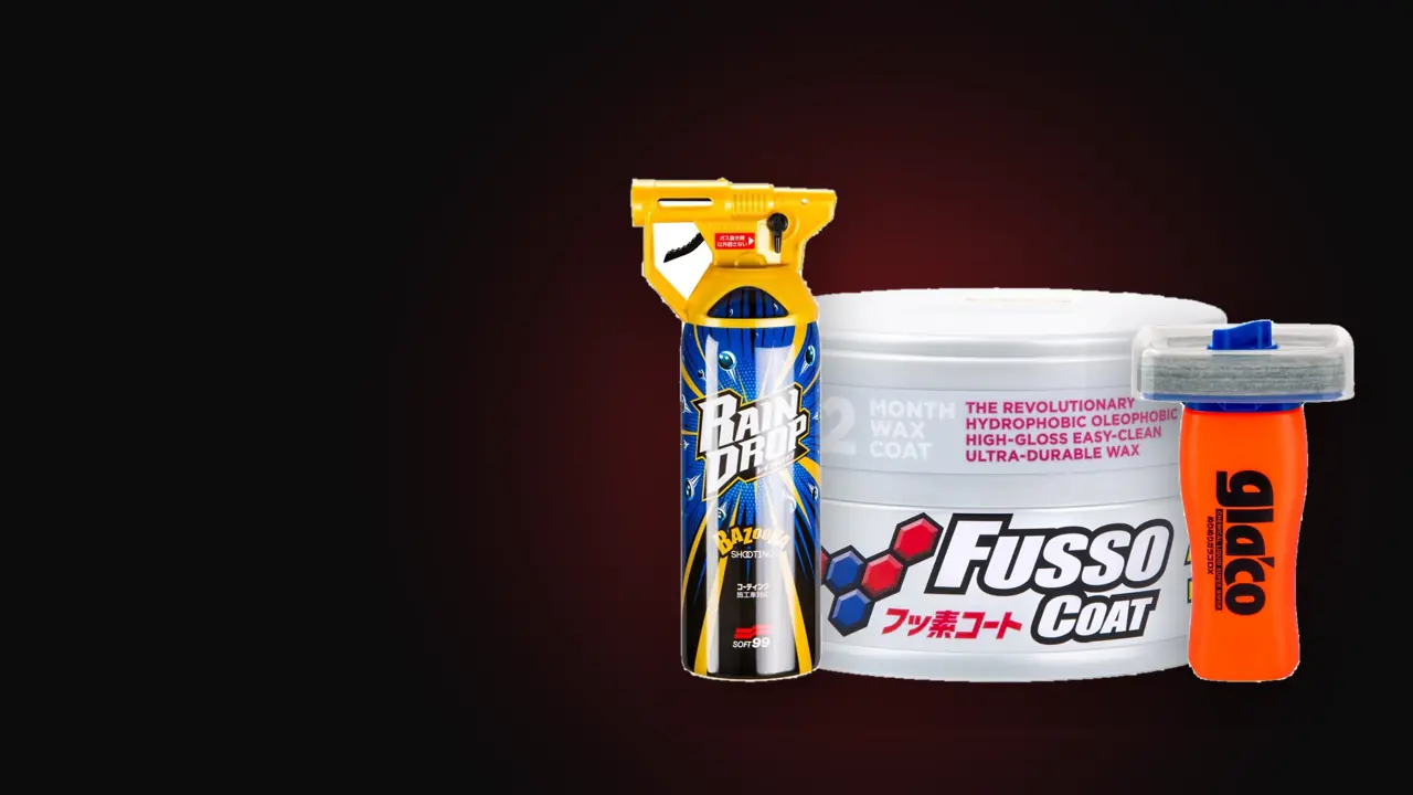 Soft99 packs: Fusso Coat 12 Months tin, Glaco DX bottle and Rain Drop spray on a dark background